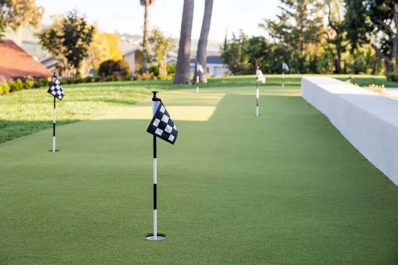 Backyard putting green with checkered flags