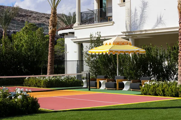 Backyard sport court with umbrella and seating in La Quinta