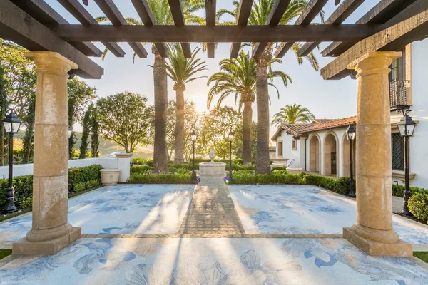 Columned pergola and decorative mosaic courtyard paving in Irvine
