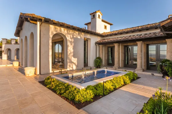 Courtyard fountain framed by clipped hedges in Irvine