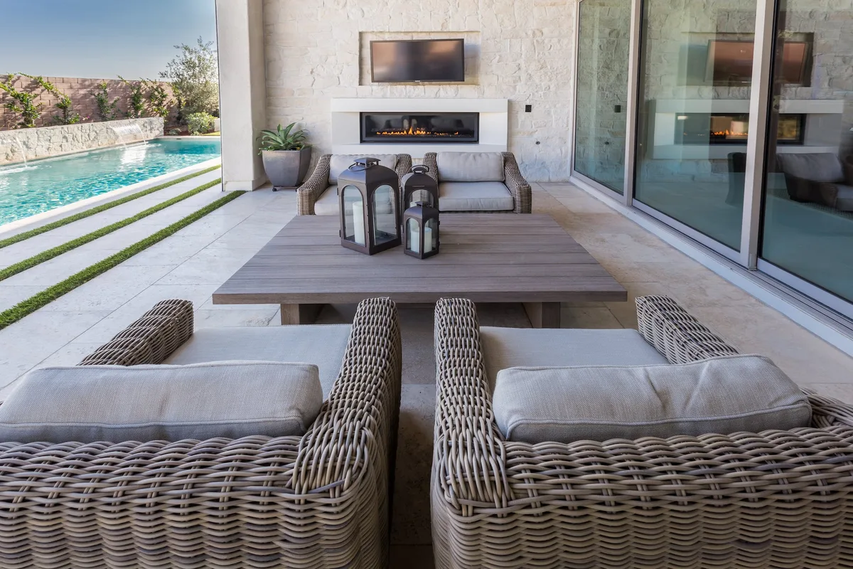 Covered outdoor dining and stone fireplace
