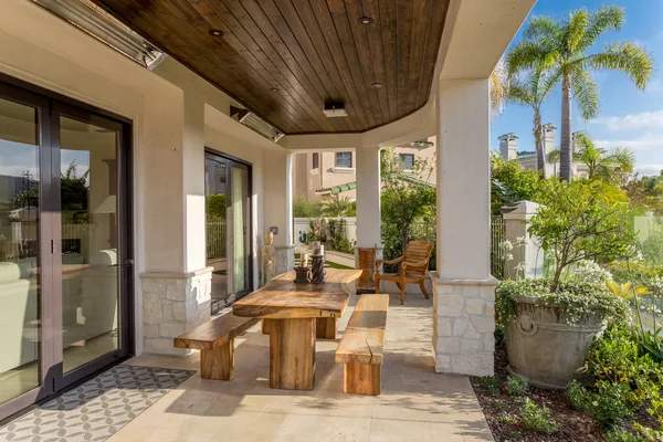 Covered outdoor dining porch with wood ceiling