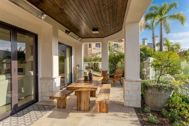 Covered outdoor dining porch with wood ceiling