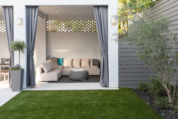 Curtained outdoor cabana with lounge seating