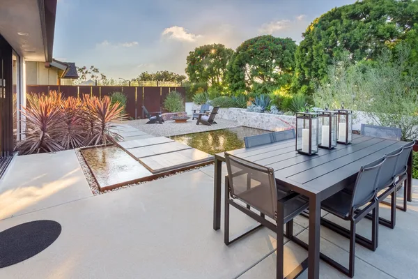 Dining patio overlooking water garden and fire seating