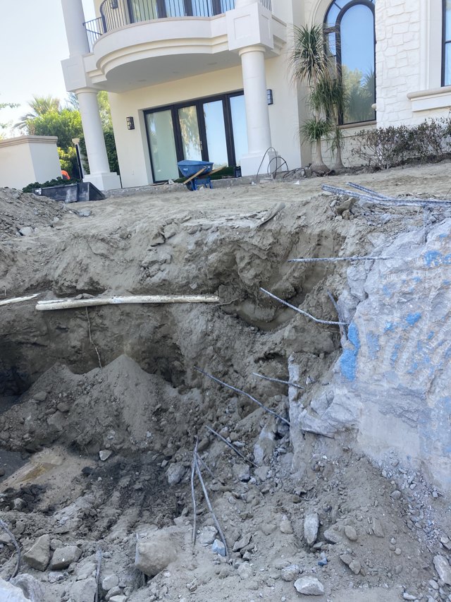 Exposed retained pool shell and demolition area