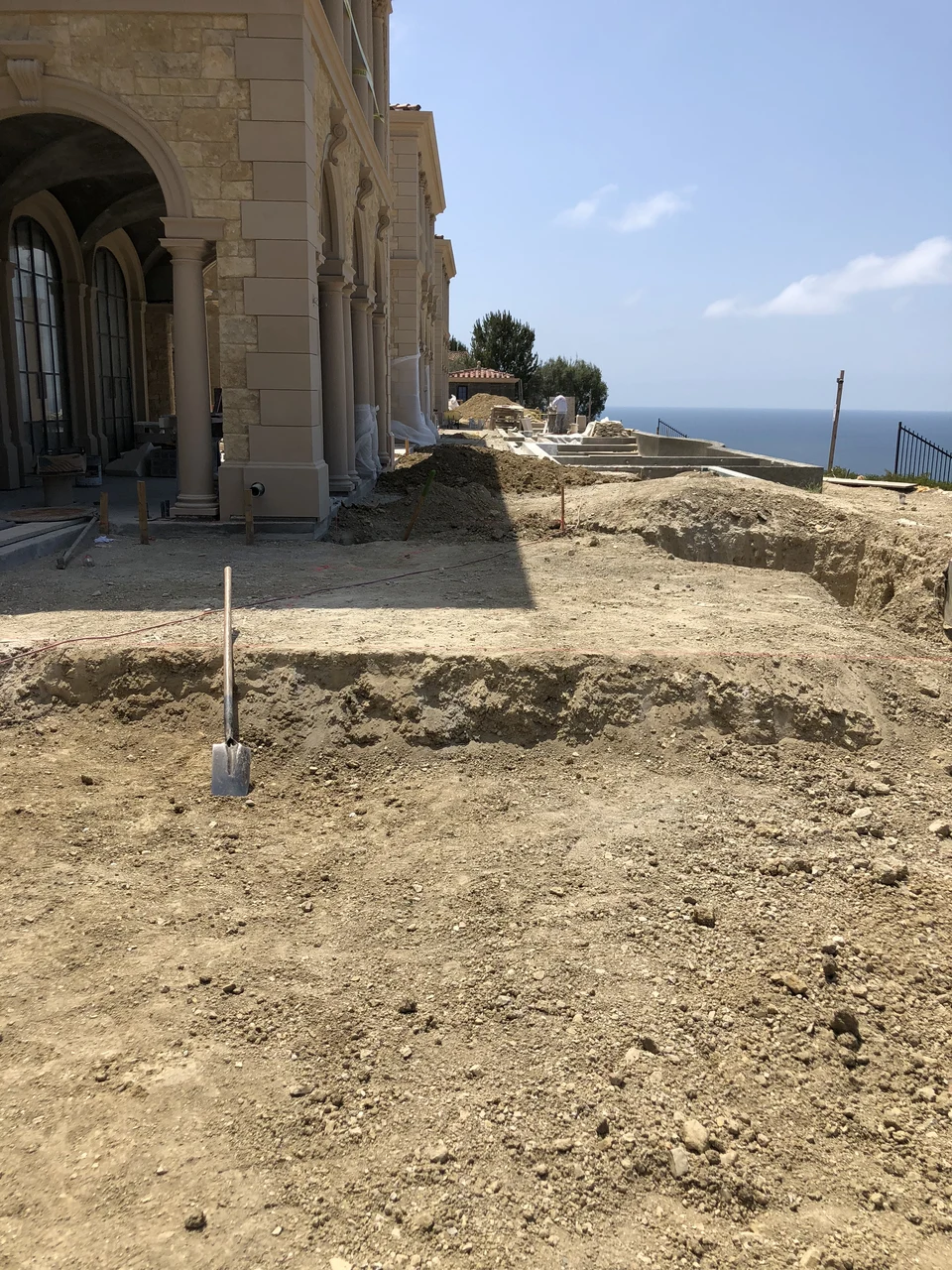 Broad excavations and changes in level along the exterior of a coastal residence