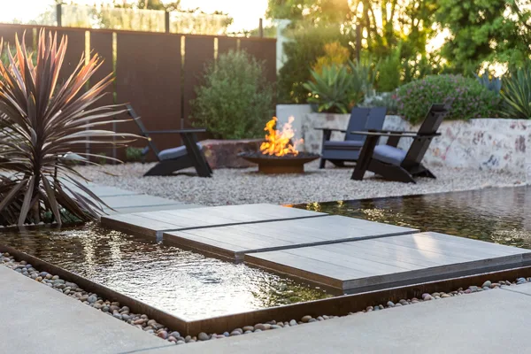 Floating stepping pads leading to garden fire bowl