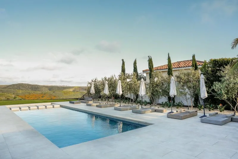 Geometric swimming pool with hillside views and loungers in Crystal Cove