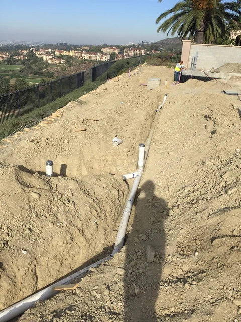 Gravity drain trench across steep hillside