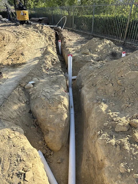 Gravity drainage pipe in open trench