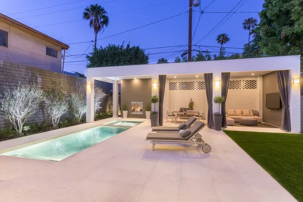 Illuminated courtyard pool lounge chairs and cabana