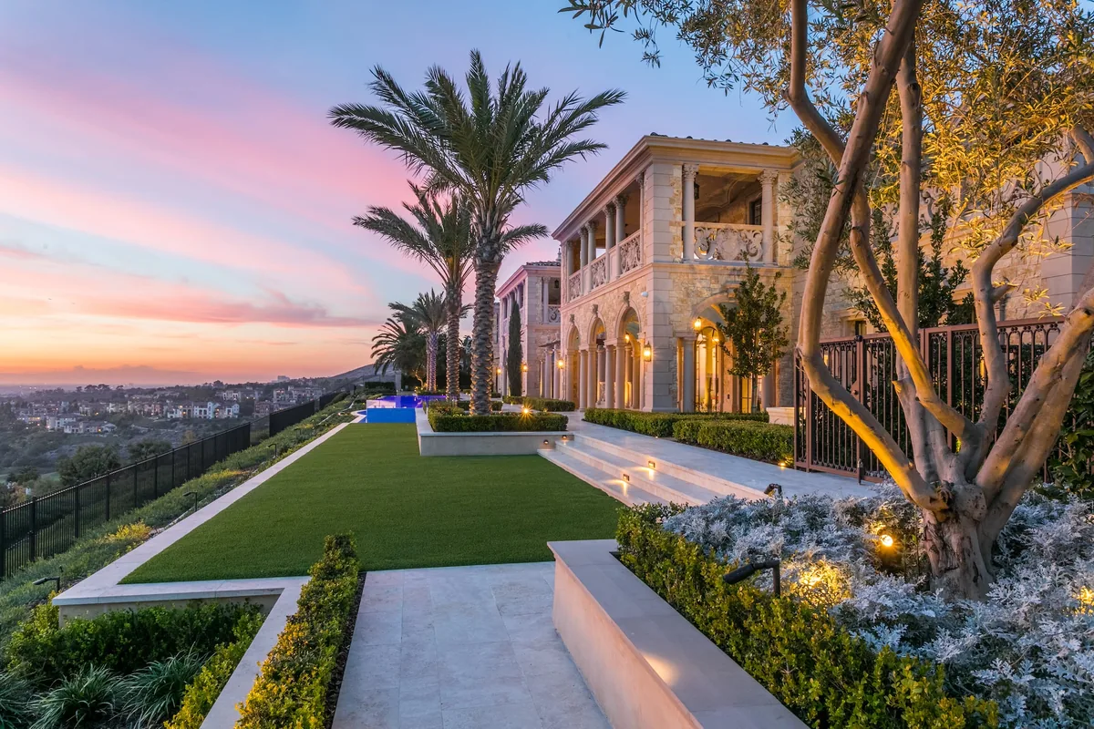 Illuminated terraced garden and palms at coastal sunset in Crystal Cove
