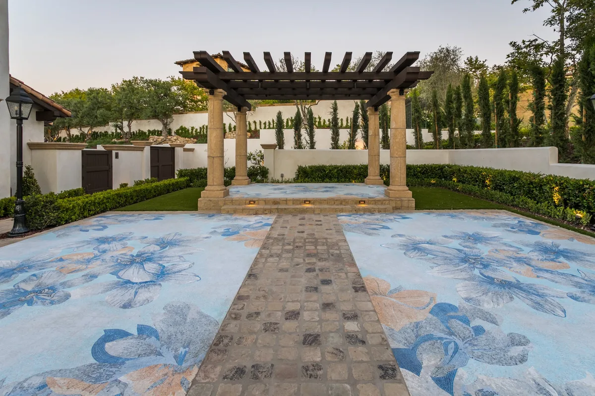 Intricate blue mosaic paving and columned pergola in Irvine