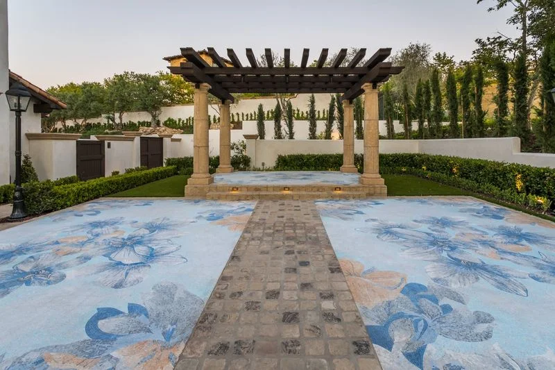 Intricate blue mosaic paving and columned pergola in Irvine