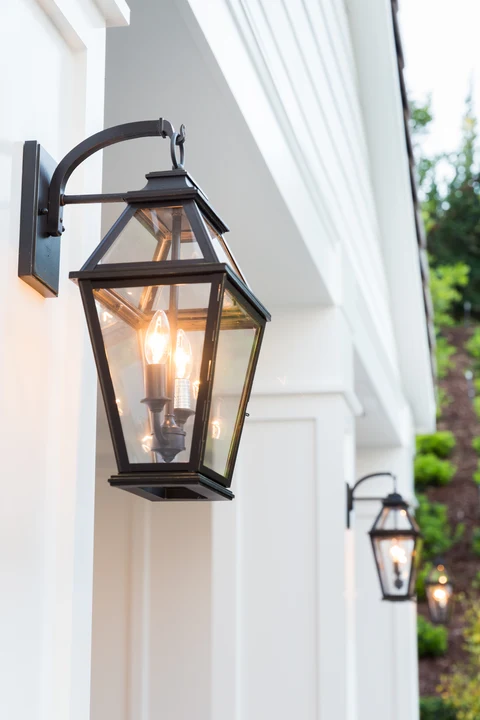 Lantern light mounted on white pool house column
