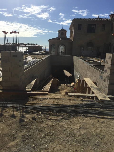 Large concrete walls and stepped site levels during construction