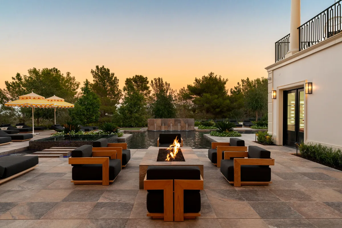 Lit rectangular fire feature with outdoor lounge seating in La Quinta