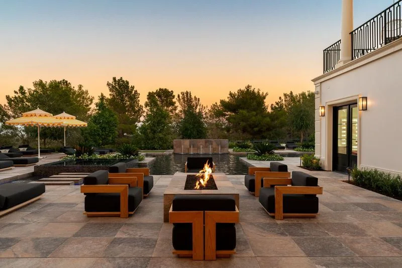Lit rectangular fire feature with outdoor lounge seating in La Quinta