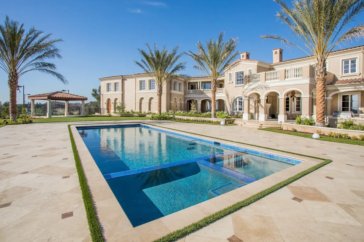Long rectangular pool with lawn banded stone deck in Coto de Caza