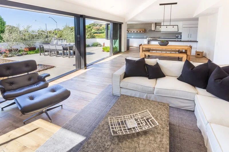Modern indoor living opening to outdoor dining terrace