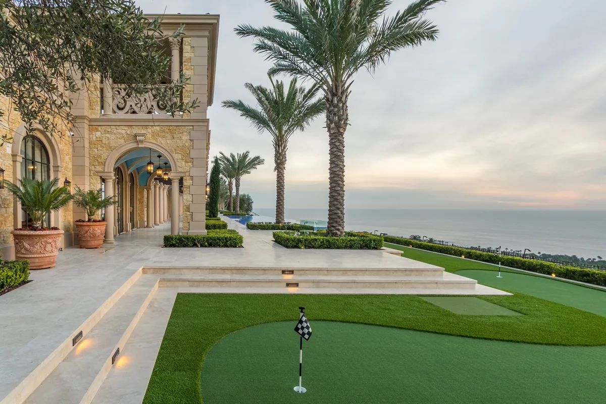 Ocean view putting green beside a stone terrace in Crystal Cove