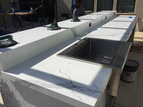 Outdoor kitchen stone countertop installation and sink