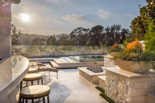 Outdoor kitchen stone spa and pool terrace