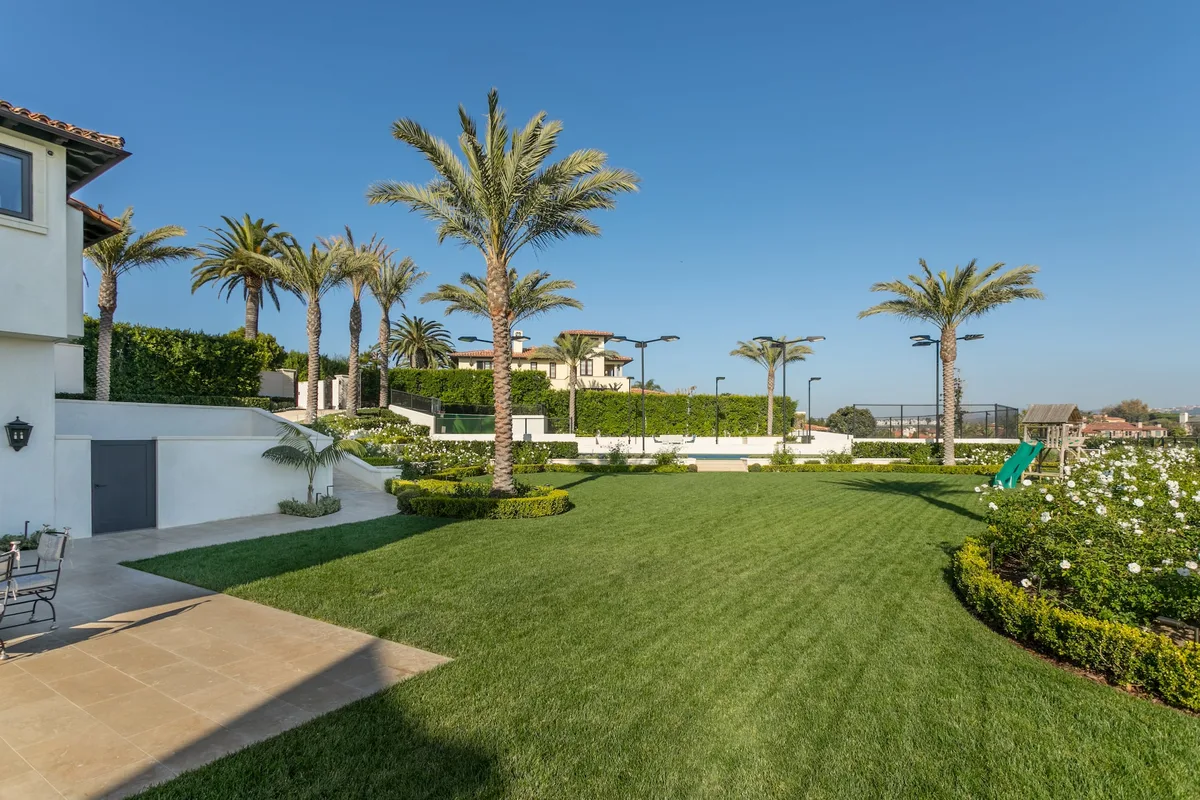 Palm lined estate lawn and flowering garden in Pelican Hill