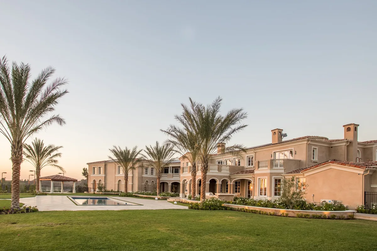 Palm lined estate lawn and swimming pool in Coto de Caza