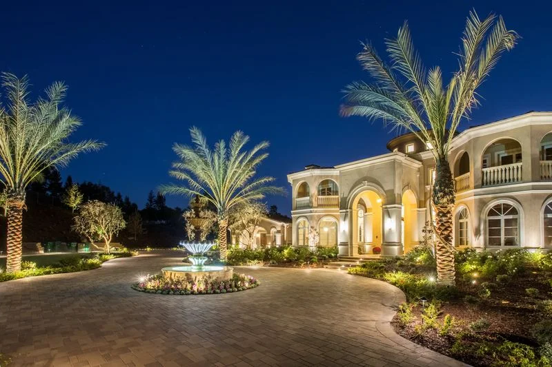 Palm lined illuminated estate entry fountain