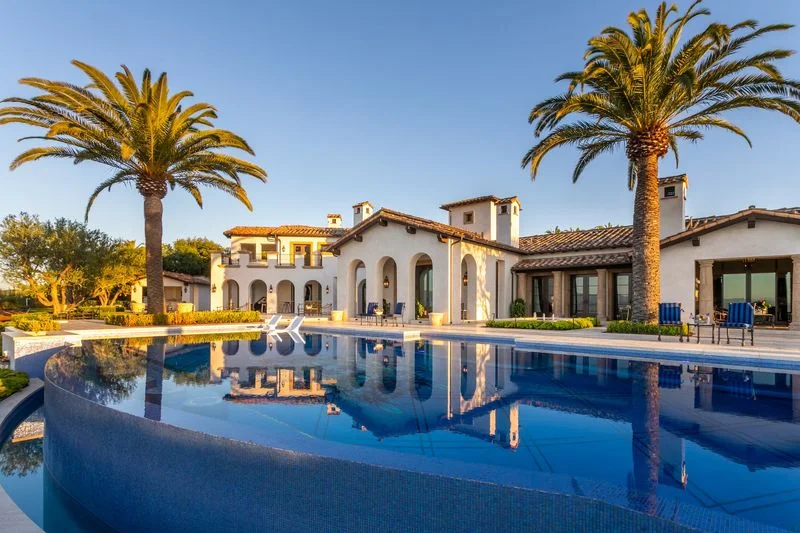 Palm reflections in curved blue mosaic pool in Irvine