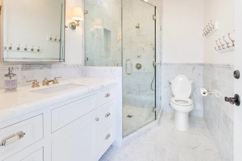 Pool house bathroom with vanity and glass shower
