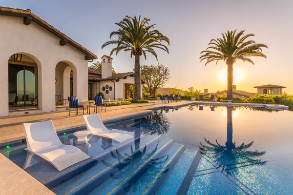 Pool sun shelf with white loungers at sunset in Irvine