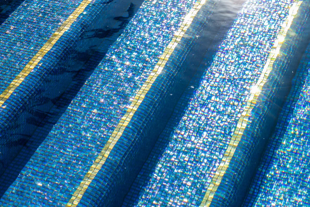 Precision blue mosaic pool steps with contrasting bands in Irvine