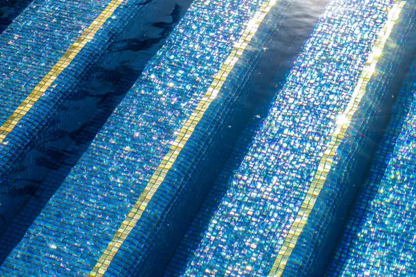 Precision blue mosaic pool steps with contrasting bands in Irvine