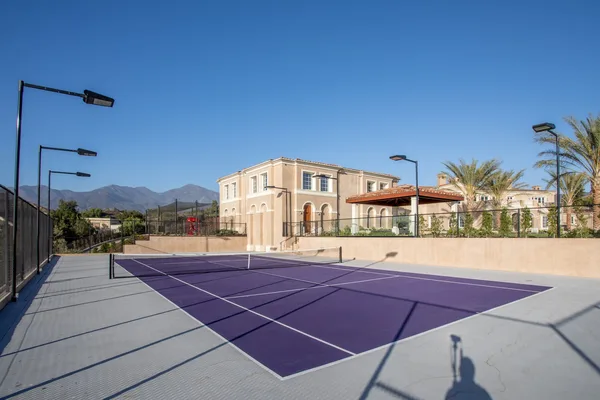 Private purple tennis court with perimeter lighting in Coto de Caza
