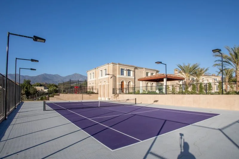 Private purple tennis court with perimeter lighting in Coto de Caza