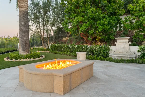 Rectangular stone fire pit in a garden terrace in Irvine