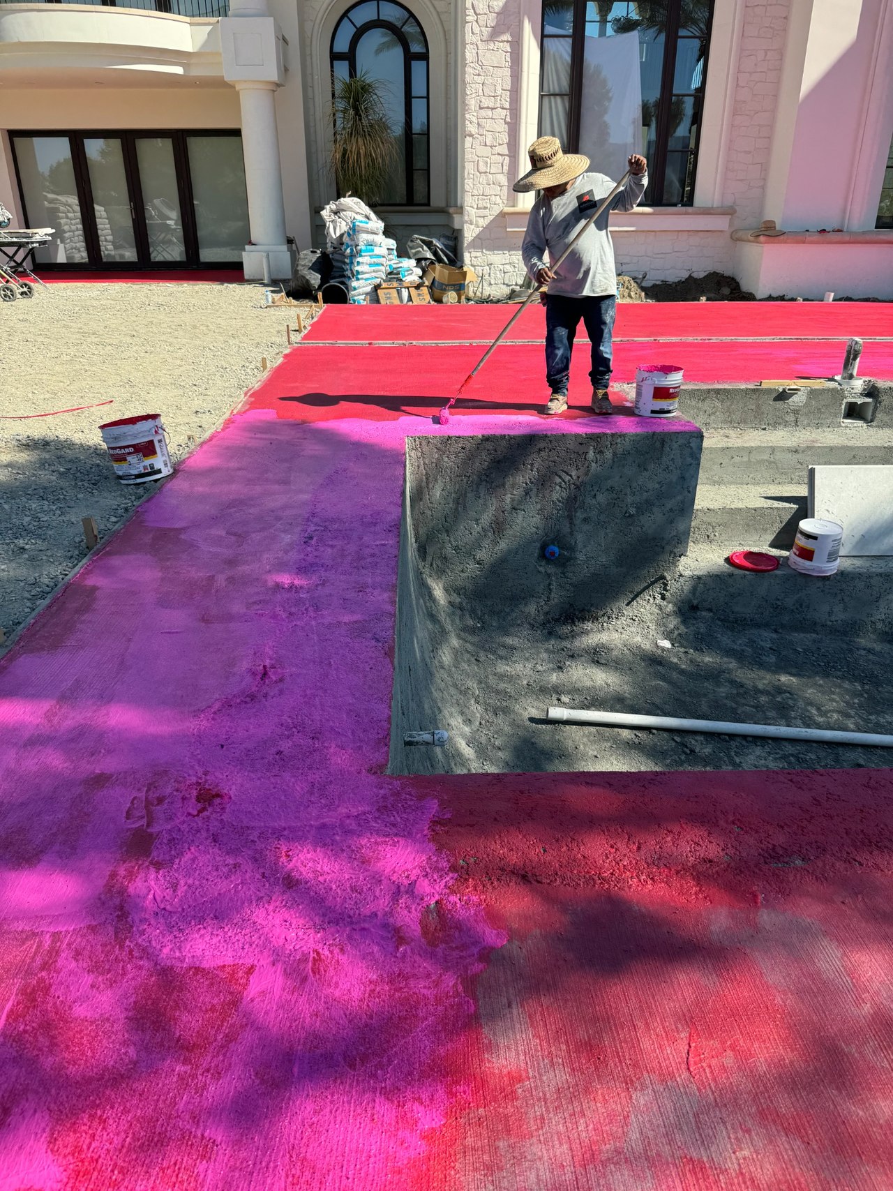 RedGard coated deck beside raised pool seating