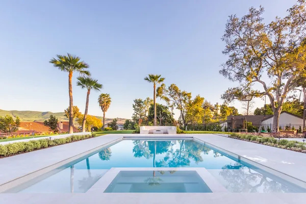 Reflecting pool and palms in soft evening light