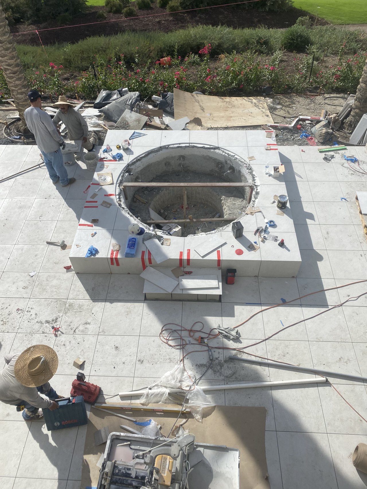 Madison Club spa during construction, showing deck tile joints aligned with the spa walls and tiled top