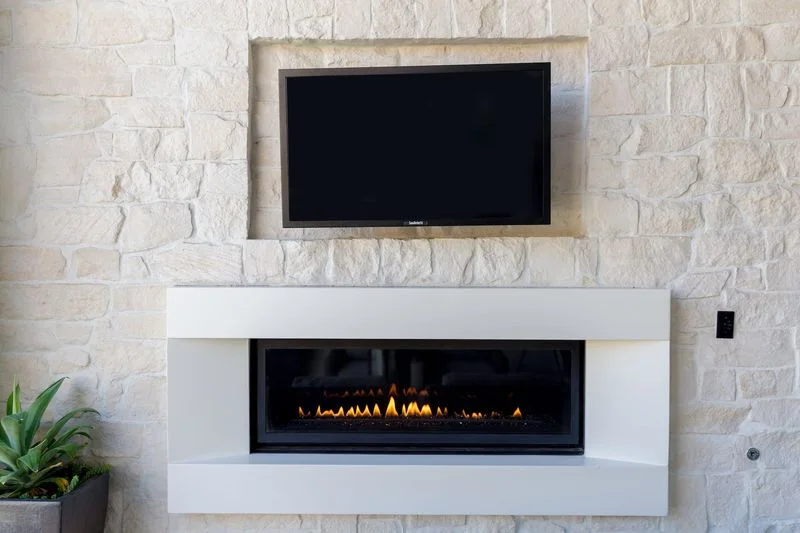 Stone outdoor fireplace wall with television