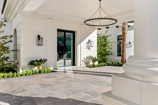 Stone paved entry porch with white columns in La Quinta