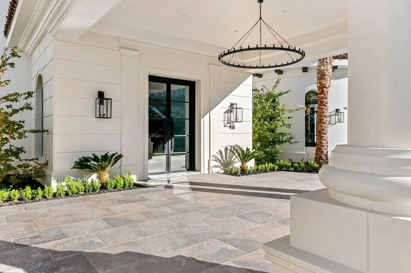 Stone paved entry porch with white columns in La Quinta
