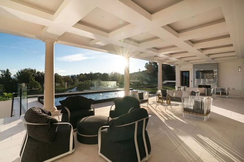 Sunlit covered terrace with outdoor seating and dining in La Quinta