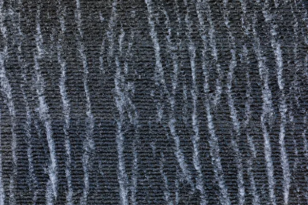 Water rippling down a dark textured water wall