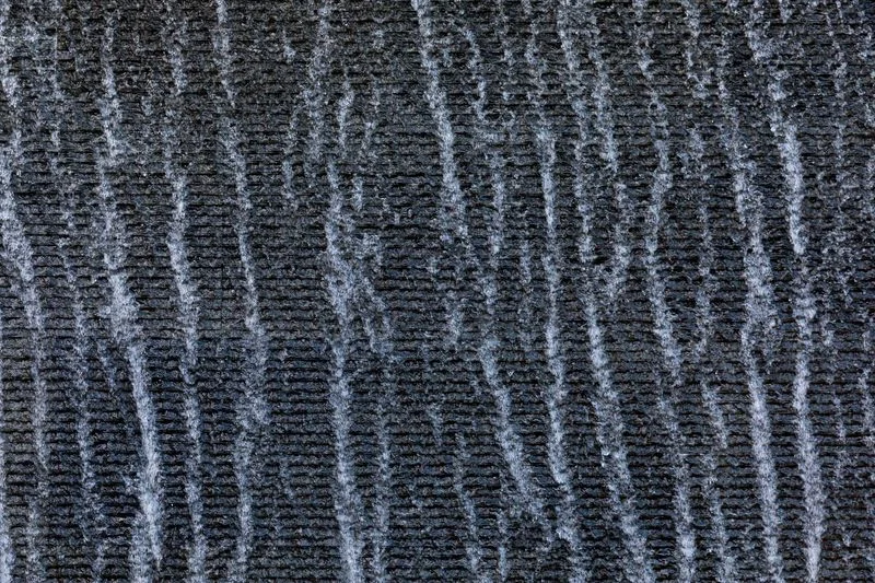 Water rippling down a dark textured water wall