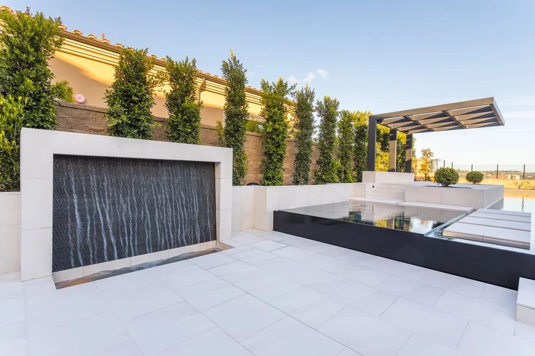Water wall and raised spa with vertical planting along the boundary