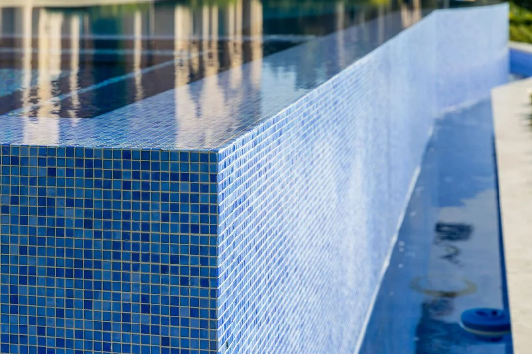 Blue mosaic tile at the edge of a raised water feature